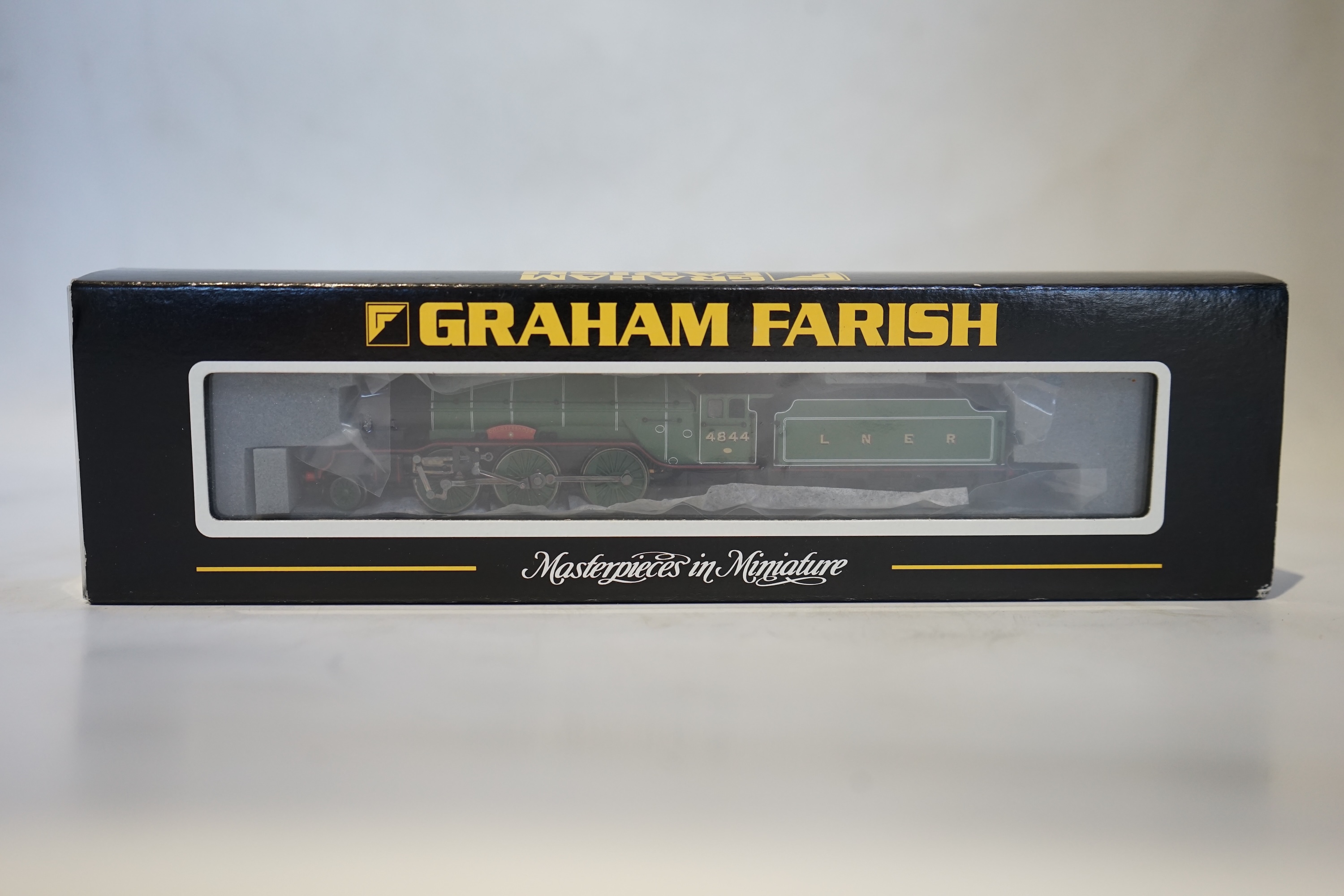 Twenty boxed Graham Farish N gauge railway; an LNER Class V2 2-6-2 tender locomotive, Coldstreamer, (372-602), together with nineteen LNER teak 4-wheel coaches. Condition - good.